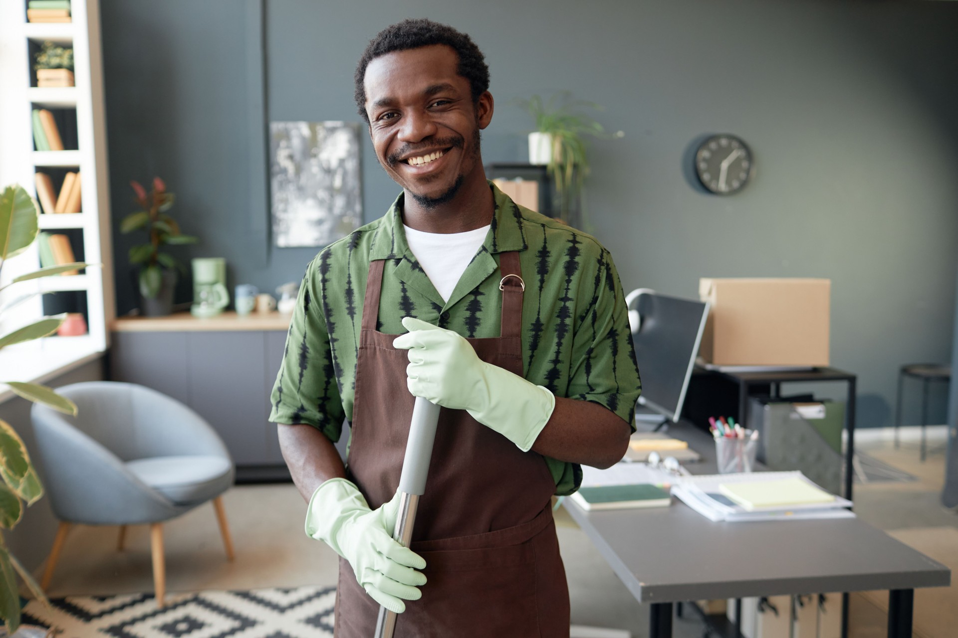 Smiling Black Man Cleaning Office and Holding Mop